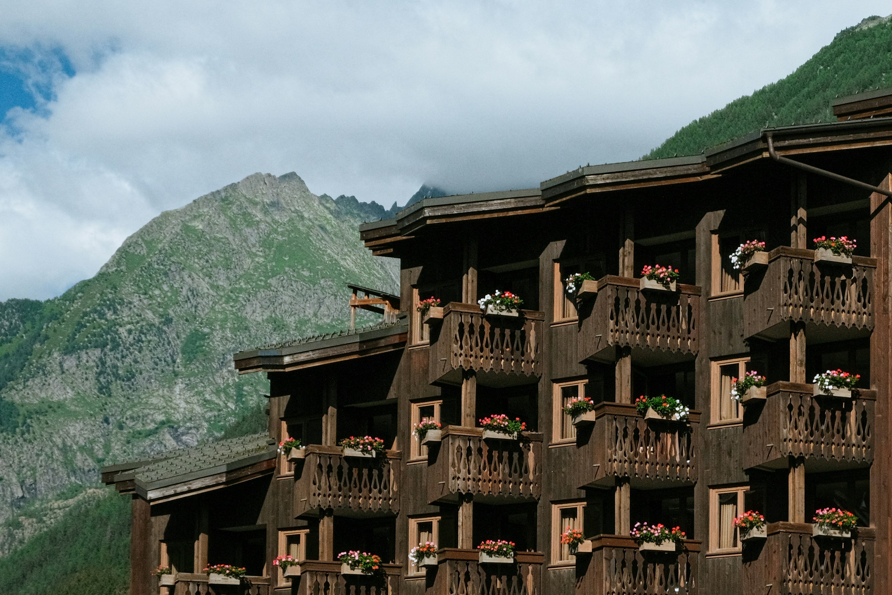 A tall wooden building with balconies on the balconies